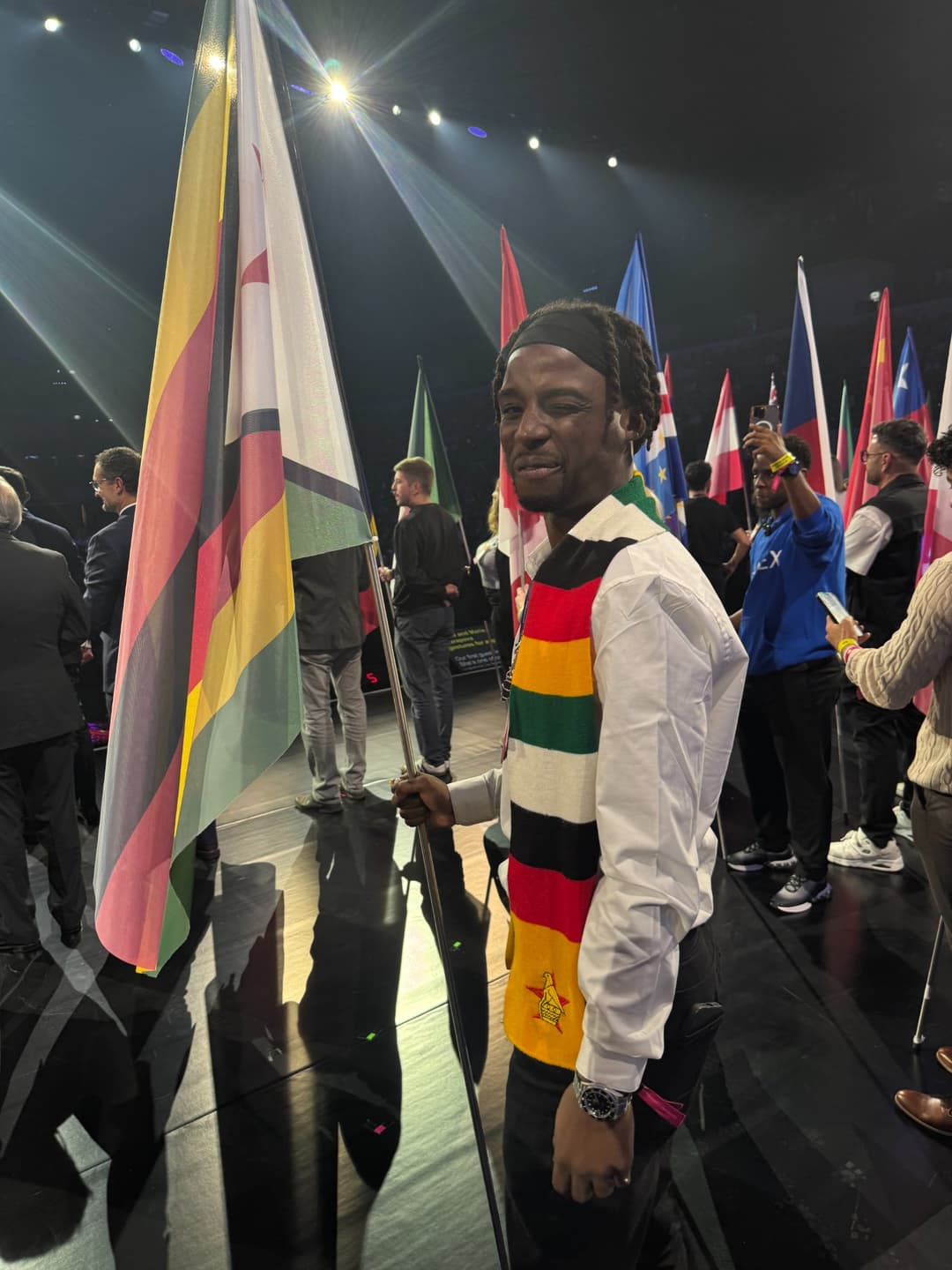 Emperor Roy holding the Zimbabwe flag at Web Summit Lisbon 2025